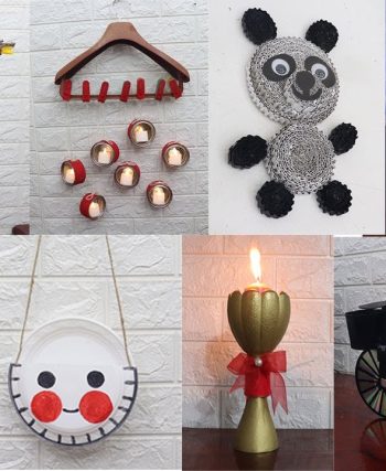 Renkli cam şişeler, karton kutular ve kumaş parçaları gibi atık malzemelerle hazırlanmış el yapımı dekoratif objelerin ahşap bir masa üzerinde sergilendiği görüntü.