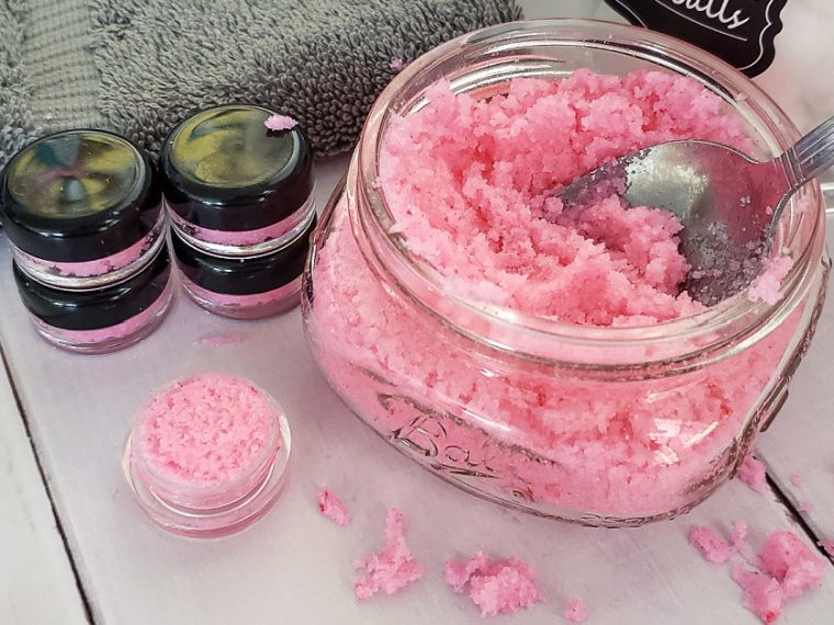 Evde hazırlanmış dudak peelingi kavanoz içinde, yanında doğal malzemeler ve fırça ile birlikte.